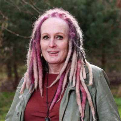 Woman smiles for a photograph while outdoors