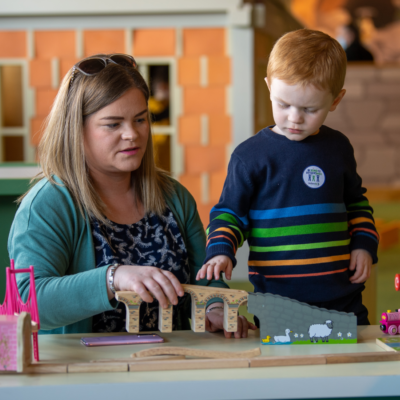 Mother and son play with toys together