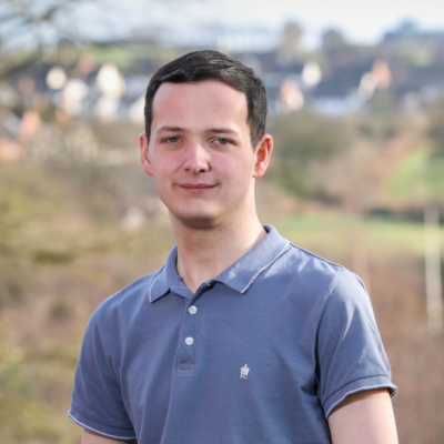 Young man outdoors smiling for a photograph