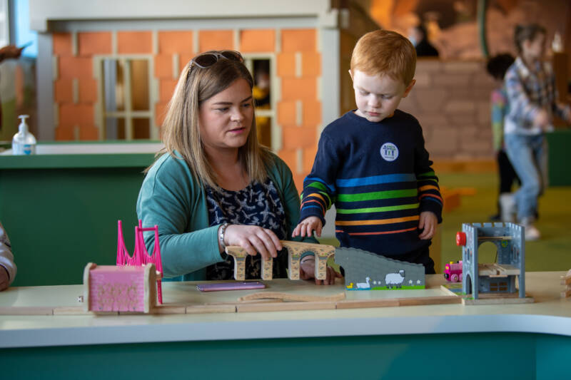 Mother and son play with toys together